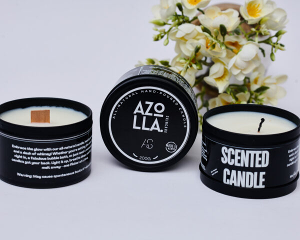 3 scented candles in black tins with 2 having open lids